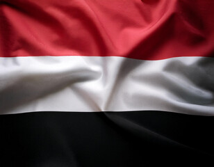 Obraz premium Republic of Yemen flag waving in the wind. Close up of Republic of Yemen banner blowing, soft and smooth silk.