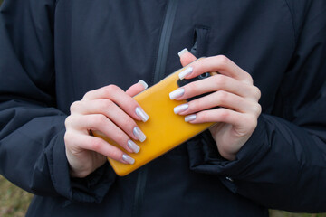 Stylish fashionable nail young woman hands mother -of -pearl manicure