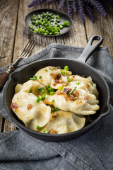Fried dumplings (pierogi) with meat filling sprinkled with greaves.