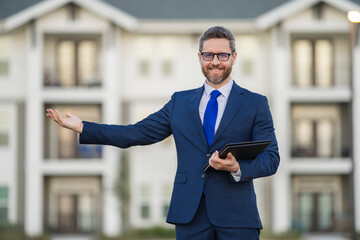 Real estate agent business man in suit hold holder clipboards outside. Hispanic Businessman. Business Man broker or real estate agent. Business man in suit outdoor. Real estate business man.