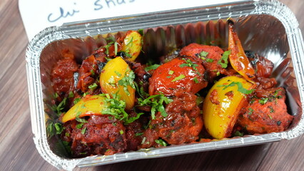 Dish of Indian chili shashlik, featuring a mix of sautéed vegetables like red and yellow bell...