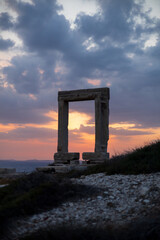 Sunset at the Portara gate of the Temple of Apollo in Naxos, Cyclades, Greece