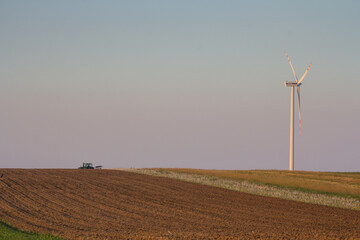Agriculture machinery in action a tractor plows a field on a bright day © Bagatela