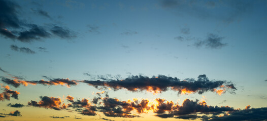 Storm. Beautiful sunset sky with clouds. Sky blue and orange light of the sun through the clouds in sky. Background of dark clouds before storm. Dramatic clouds. Apocalyptic sky, dark cloud.