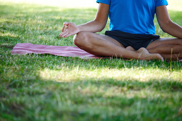 Grass, hands and man for mediation on mat with mindfulness, peace and calm for mental health. Male person, outdoor and lotus pose at park with zen for spirituality, relax and self care or calm