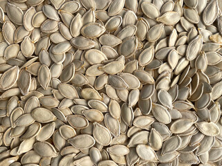 Organic pumpkin seed. Texture or background concept. Lots of pumpkin seeds.