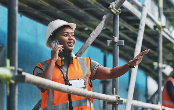Building, construction and black woman with phone call, advice or communication in architecture. Developer, contractor or project manager at scaffolding on smartphone for civil engineering discussion