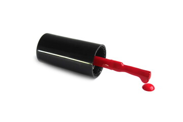 A nail polish brush with red varnish lies on a white background.