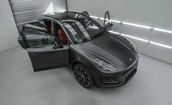Rostov-on-Don, Russia - October 7, 2024: Porsche Macan with open doors stands in the detailing studio. Car care