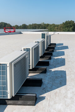 Airco with heat pump, Air compressor on the roof of a building, Air conditioning installed on the roof of a tall building, Air conditioning, heat pump,