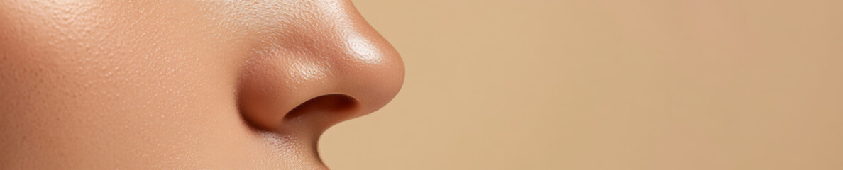 Fototapeta premium Banner with copy space. Close-up of a woman's flawless, radiant nose skin, showcasing skincare and beauty, with plenty of room for text or design elements