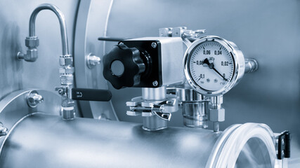Pressure gauge attached to pipe, industrial chemical or pharmaceutical equipment concept background