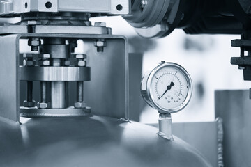 Pressure gauge attached to pipe, industrial chemical or pharmaceutical equipment concept background