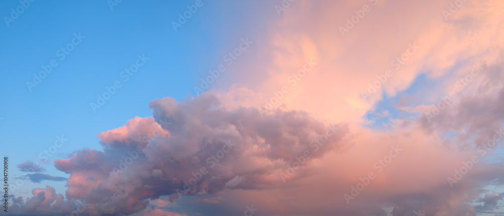 Poster a beautiful blue sky with a few clouds and a pinkish hue. the sky is clear and the clouds are scatte