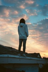 Fototapeta premium Person standing on the rooftop with an uncertain or adventurous atmosphere
