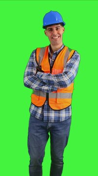 vertical Smiling construction engineer crossing arms while looking at the camera chroma key