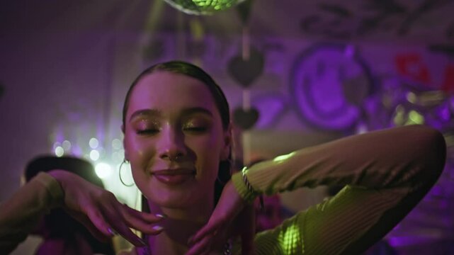 Sexy girl partying club neon lights closeup. Portrait of sensual woman dancing