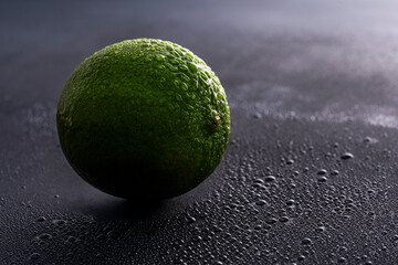 Citrus lime fruit on black background