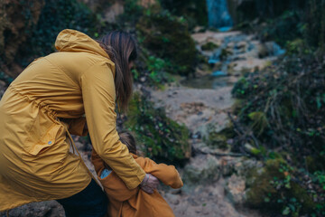A mother with her young daughter embrace the tranquility of the outdoors as they take in the scene...