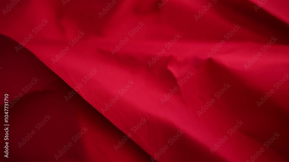 Aufkleber a striking red fabric is beautifully arranged with flowing folds and gentle creases. the soft lighti