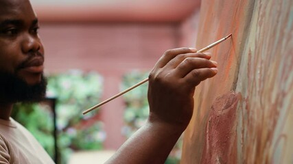 Painter uses a variety of brushes and paint tubes to create masterpiece for the fine art gallery exhibition, creative atelier. Working on colorful artwork with creativity and dedication. Camera A.