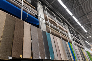 Large assortment of carpets for sale in a store.