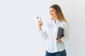 Caucasian businesswoman in formal attire in her office happy and cheerful while using smartphones 