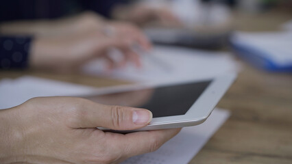 Fototapeta premium Accountants or auditors reviewing financial documents while sitt