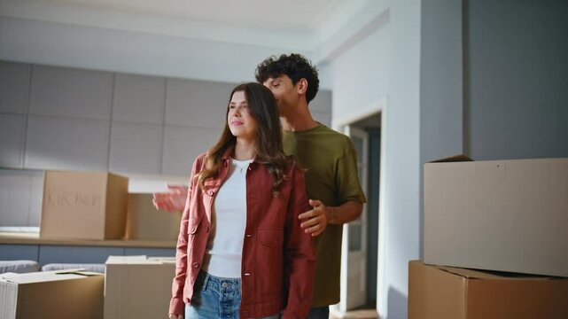 Boyfriend making surprise girlfriend entering home with cardboard boxes closeup