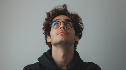 Fototapeta premium Thoughtful Young Man Gazing Upwards