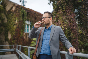 Businessman drink alcohol from flask during workday