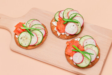 Crispy Cracker Sandwiches with Fresh Salmon, Cucumber, Radish, Cottage Cheese and Green Onions. Easy Breakfast. Quick and Healthy Sandwiches. Crispbread with Tasty Filling. Healthy Dietary Snack