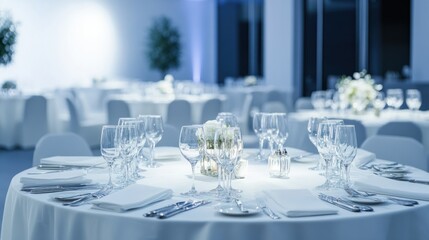 Elegant corporate event venue with round tables set with white linens, crystal glasses, and soft ambient lighting, isolated on white