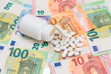 Expensive Medicine and Inflation Concept: Pills and Capsules on the Euro Banknotes. Global Pharmaceutical Industry and Big Pharma. Euro Money Bills