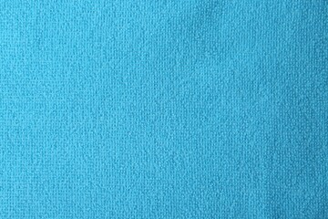 Clean light blue microfiber cloth as background, top view