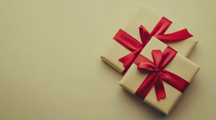 Elegant Valentine's Day gifts wrapped with red ribbons on a soft beige background