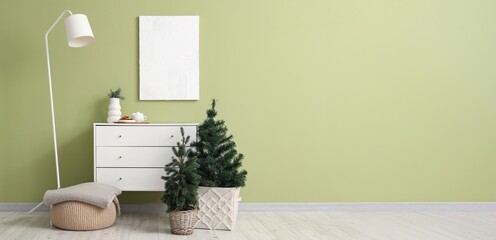 Stylish interior of living room with Christmas trees and chest of drawers. Banner for design