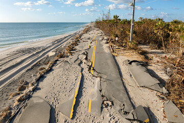 Destroyed Manasota Key road at Blind Pass Beach after Hurricane Milton storm surge. Severe damage to waterfront infrastructure in Florida.