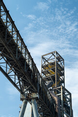 Tall equipment at the steel plant under the blue sky.