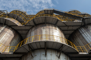Fototapeta premium Tall equipment at the steel plant under the blue sky.