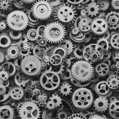 A collection of various mechanical gears and cogs in grayscale.