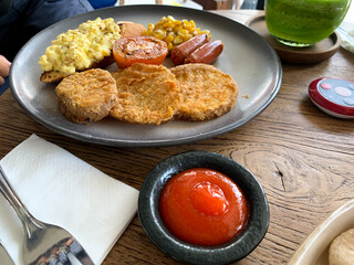 Mix Breakfast with beef, sausages, scrambled egg, mushrooms, tomato, corn on the plate