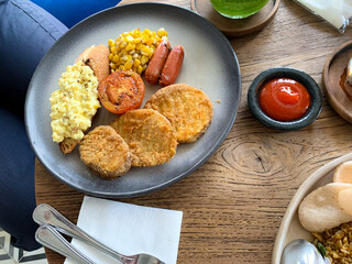 Mix Breakfast with beef, sausages, scrambled egg, mushrooms, tomato, corn on the plate