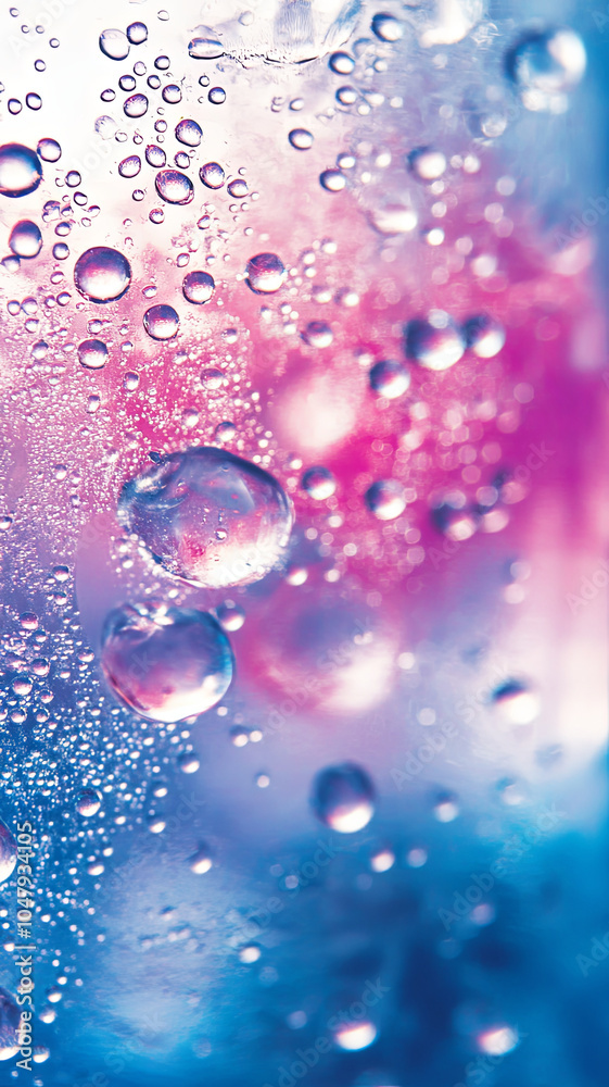 Wall mural bubbles and droplets create mesmerizing pattern on colorful background, evoking refreshing and cool 