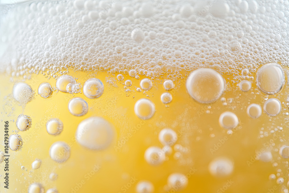 Wall mural refreshing bubbles in glass of golden beverage create lively and inviting atmosphere. foam adds touc