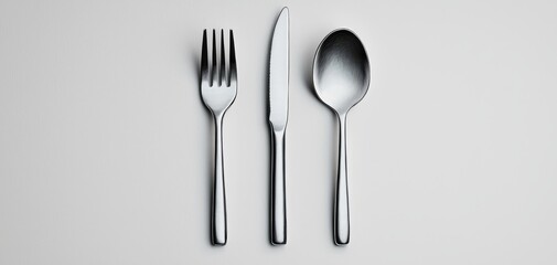Elegant Silver Cutlery Set Arranged in Symmetry on White Background - Minimalist Kitchenware Concept for Culinary Designs