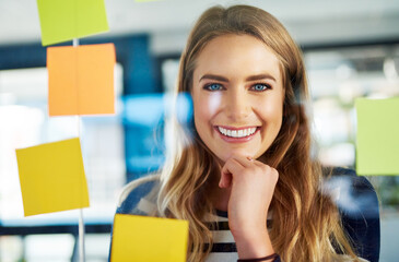 Portrait, business and woman with notes on glass wall for planning, future ideas and creative...