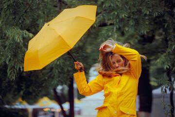 Woman in Discomfort from Wind During a Rainstorm Tempest. Unhappy lady feeling uncomfortable during...