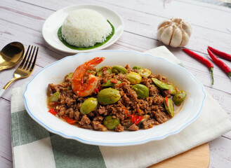 Stir fried bitter bean with minced pork and shrimp - Thai food called Sator at close up view 