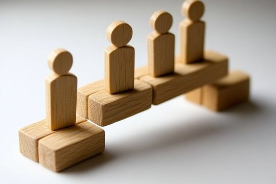 Wooden Figures Standing on Building Blocks